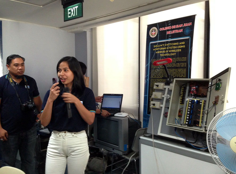 Colegio De San Juan Letran 5th year computer engineering student Frances Marie Kagahastian demonstrates the SMS.AWT: Switching and Monitoring System Using Android in Wireless Technology, a system that allows people to control and monitor lights and appliances in their homes from anywhere. (Photo by Max Limpag)