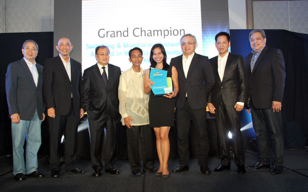 Frances Marie Kagahastian of Colegio De San Juan Letran receives her award for winning the top prize in the 9th SWEEP Innovation and Excellence Awards. With her are (from left) PLDT-Smart public affairs head Ramon Isberto, PLDT president and CEO Napoleon Nazareno, PLDT and Smart chairman Manny Pangilinan, her teacher-mentor, an official from the Department of Science and Technology, PLDT and Smart technology head Rolando PeÃ±a and technology group head Mar Tamayo. (Photo provided by Smart)