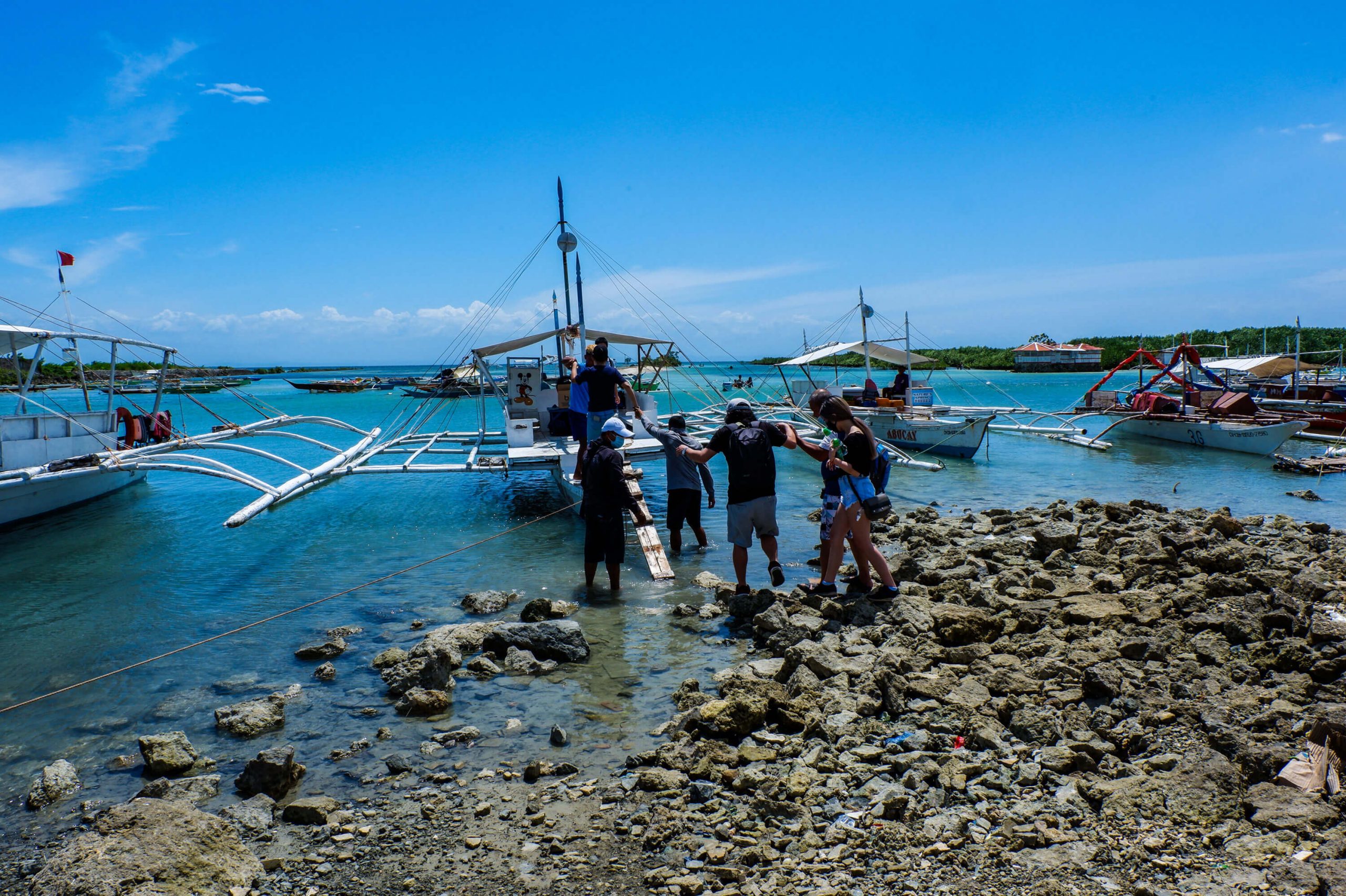 Members of the Central Visayas Information Sharing Network Foundation, Inc. (CVISNet) head to Gilutungan Island for the setup of LACS to power online education in the barangay.
