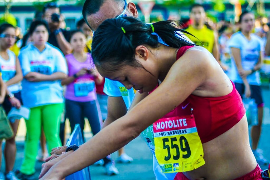 SHE GAVE HER ALL. Aileen Tolentino collapses after winning the Cebu City Marathon 42K Women’s event.(PHOTO BY IGI MAXIMO OF PabolFC.com)
