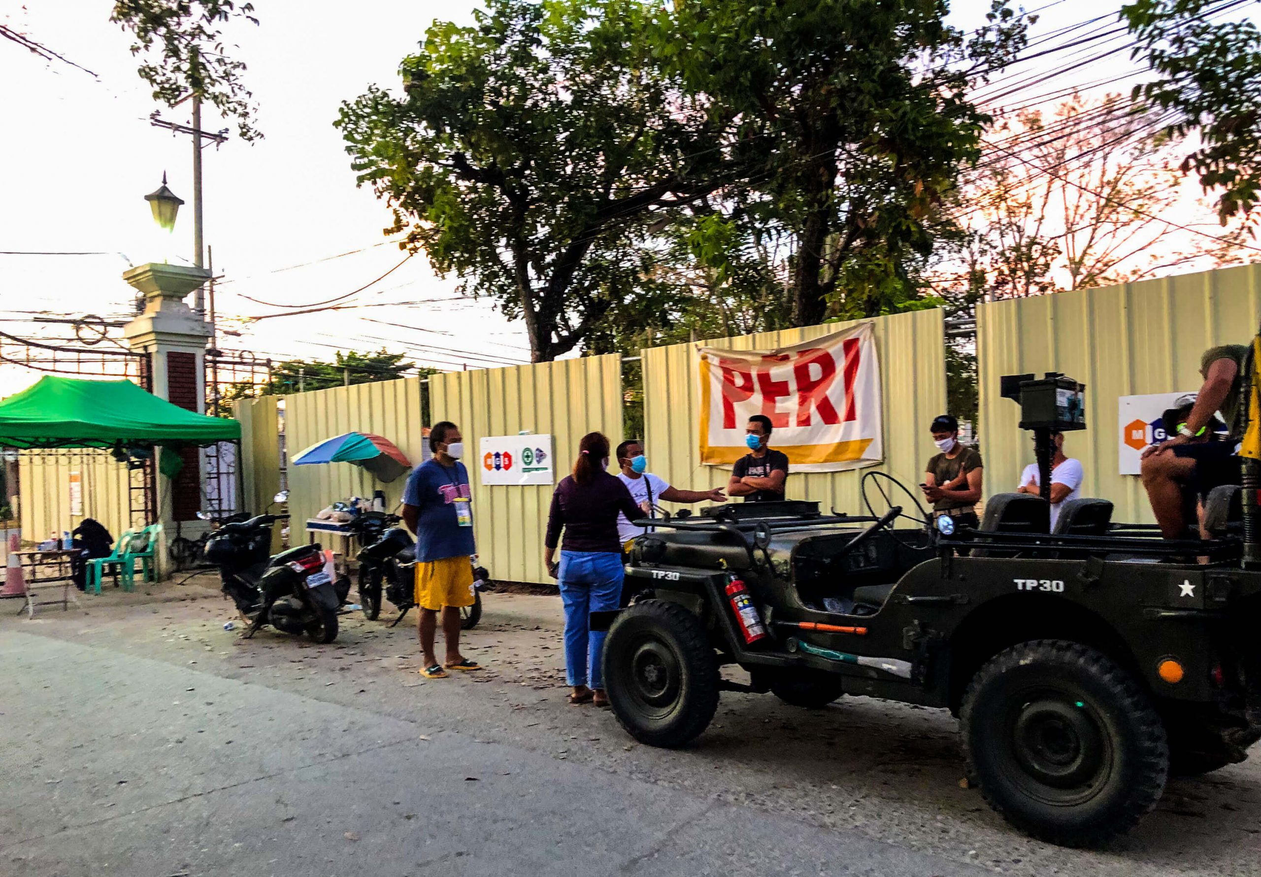 A subdivision official talks to a barangay official and a soldier during an argument at the gate of Camella Homes in Pajac, Lapu-Lapu City. The argument was over the decision to let through a car that was reported to be carrying "someone from Barrio Luz." At this time, Barrio Luz in Cebu City was put on strict lockdown because of soaring COVID-19 cases.
