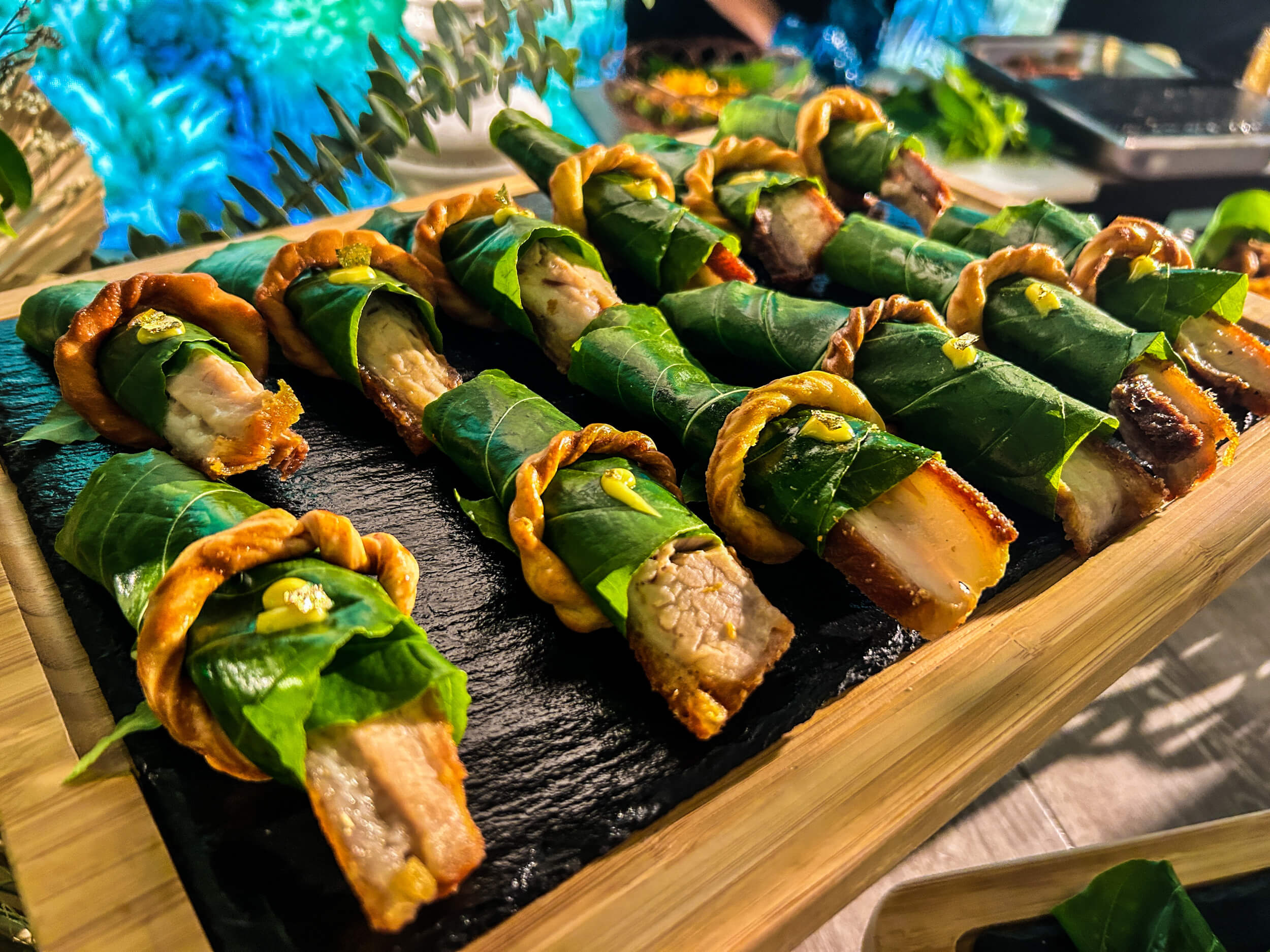 PORK LECHON DOLMADS, a dish of roasted pork marinated in local green mangoes and wrapped in kolis leaves.This is a creation by Chef Sau del Rosario, billed as the “Godfather of Philippine Cuisine.”